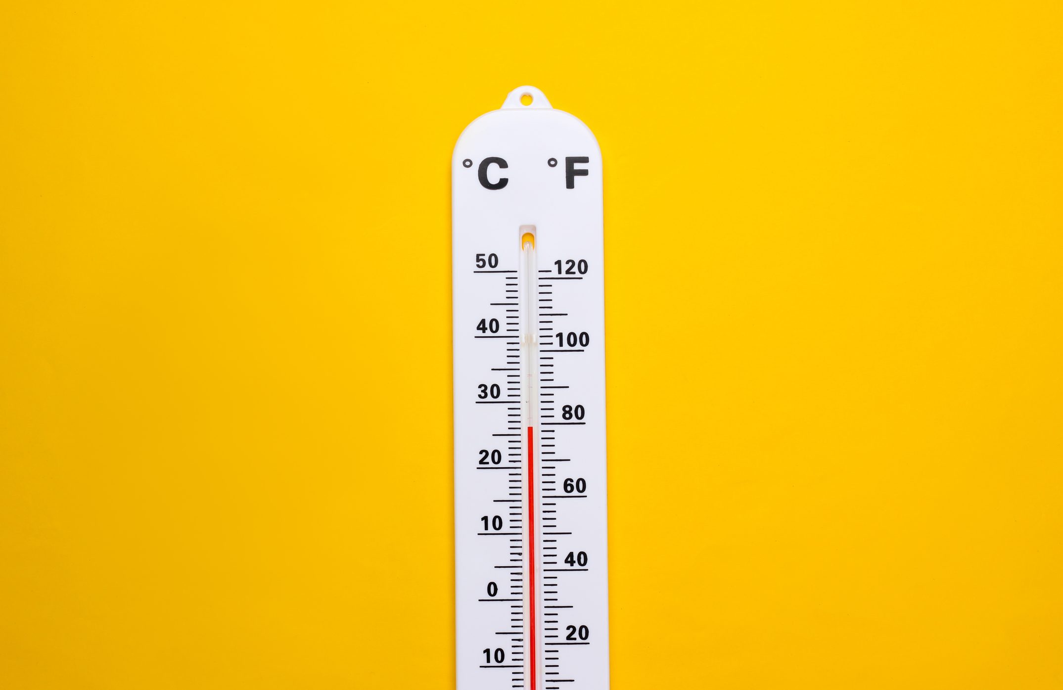 Weather thermometer on yellow background. Climate control. Top view