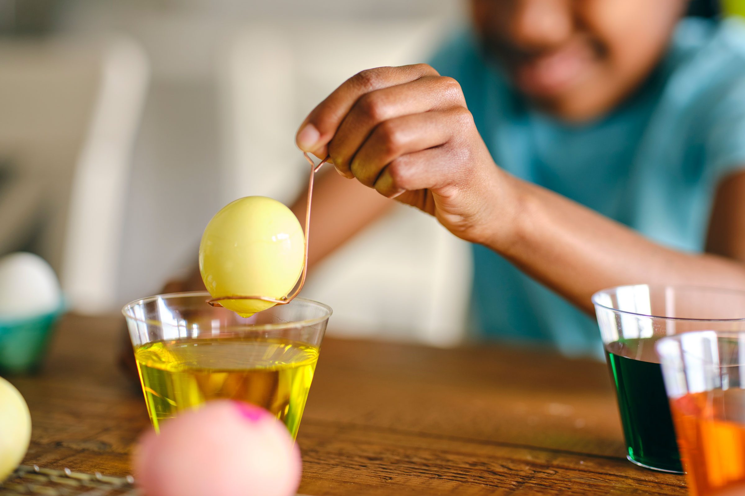 kid decorating easter eggs