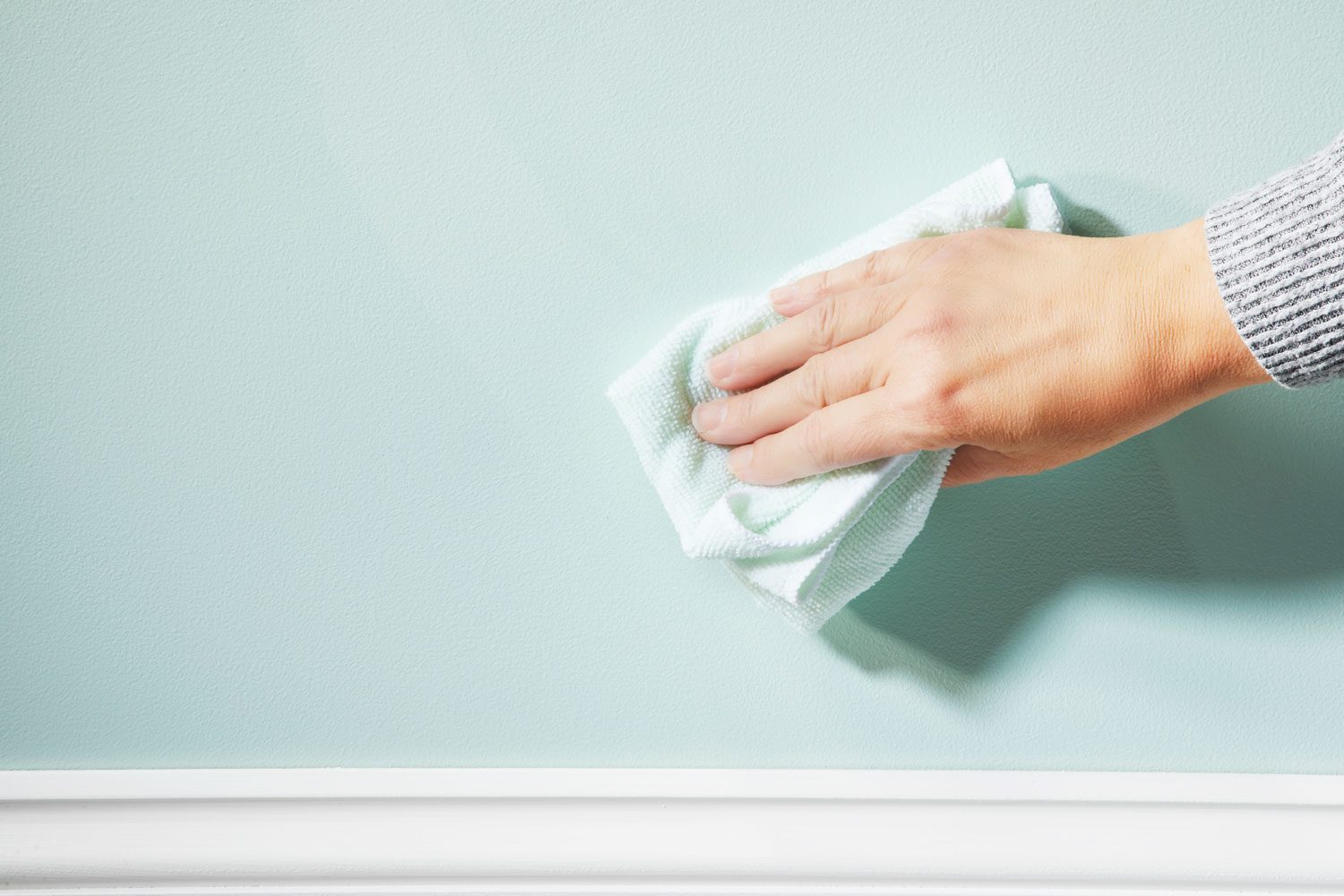 Rinsing the wall after crayon stains have been removed