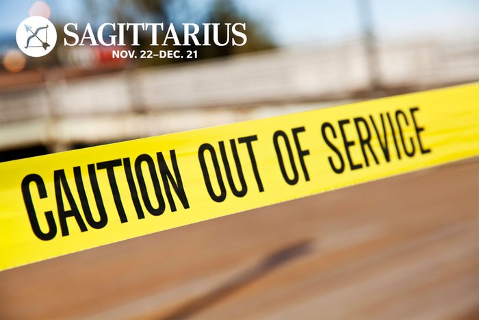 caution out of service tape with Sagittarius zodiac in upper left corner