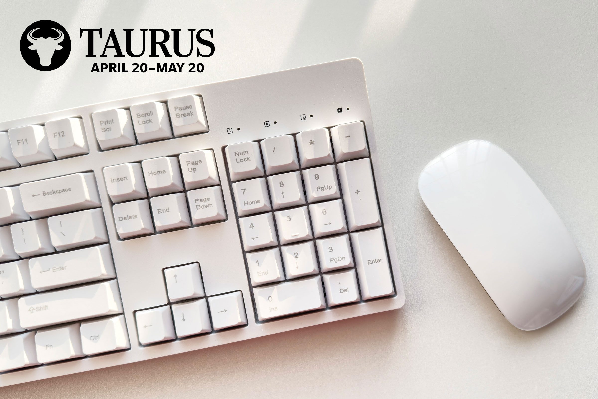 copmuter keyboard and mouse with taurus zodiac in upper left corner