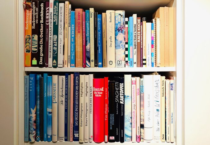 Cookbooks on white shelves