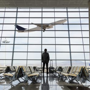 Businessman with luggage waiting in the airport