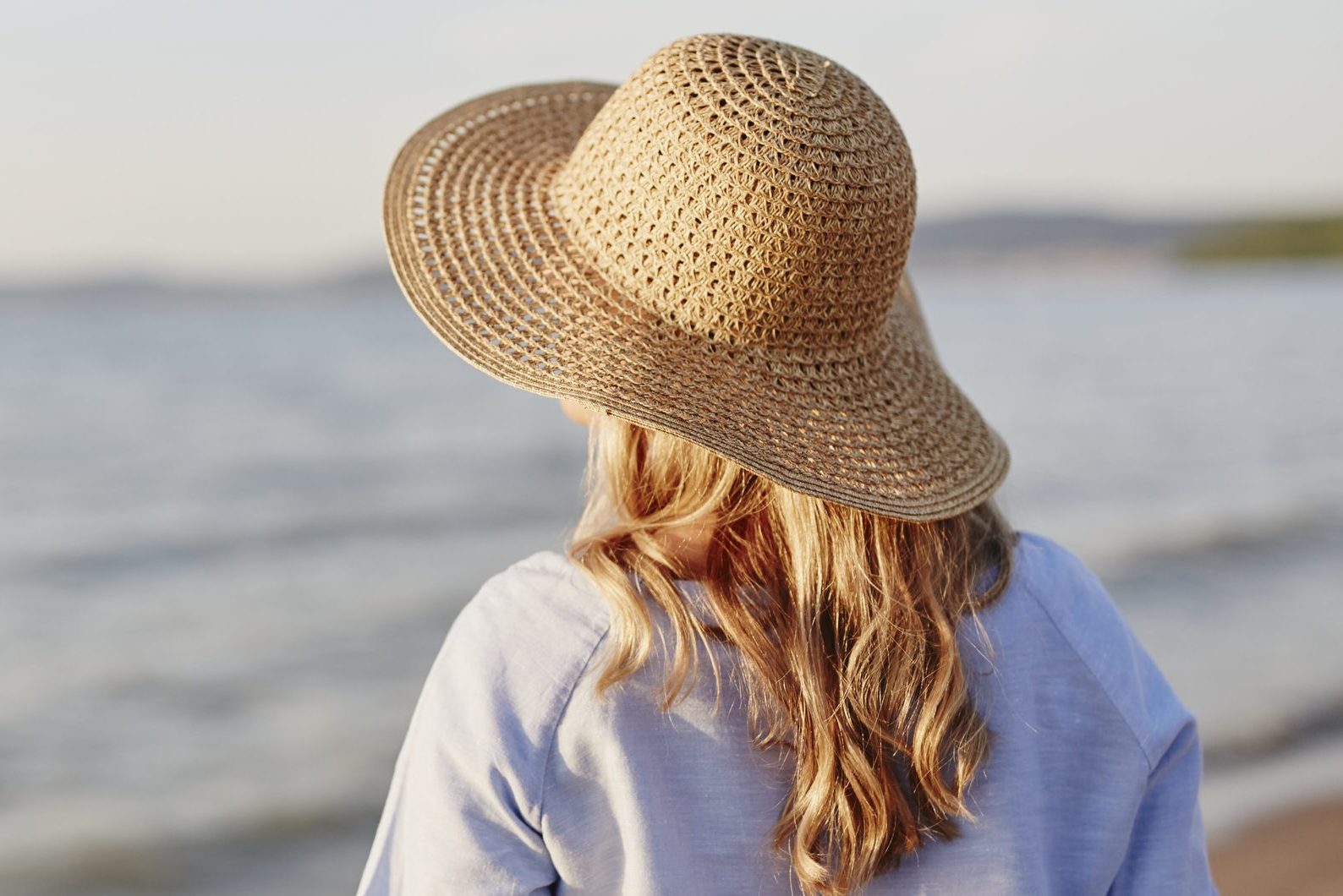 Woman wearing straw hat on beach