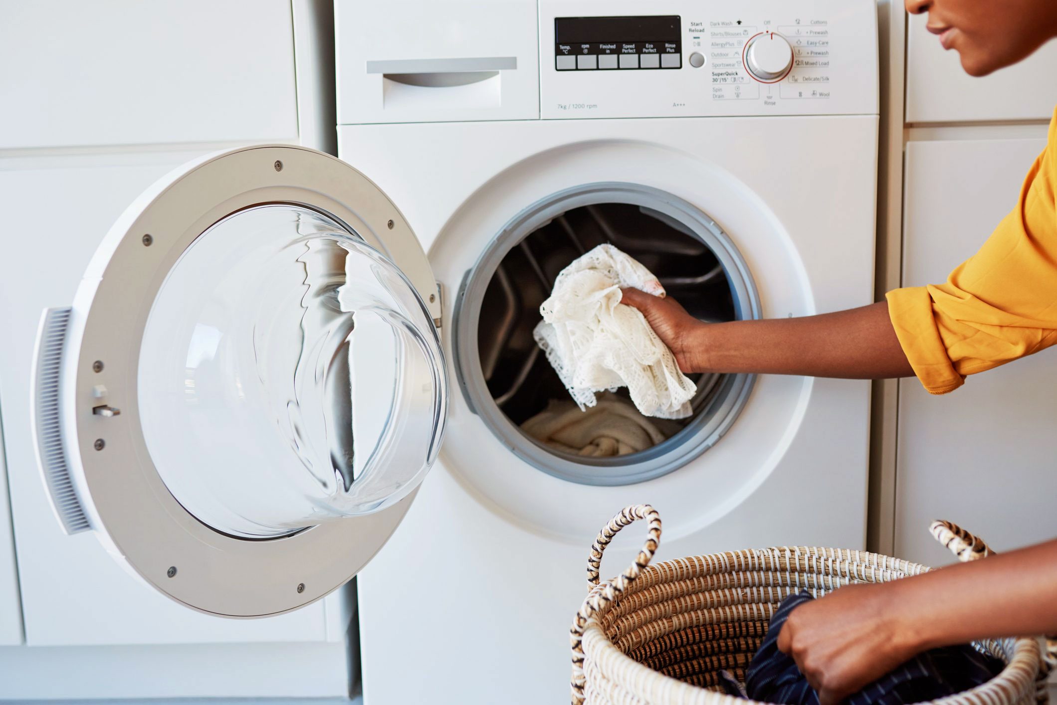 woman loading washing machine