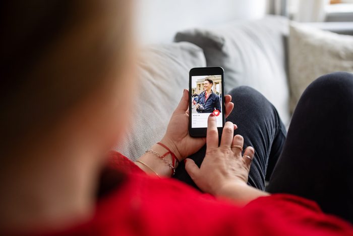 Woman using dating app on mobile phone