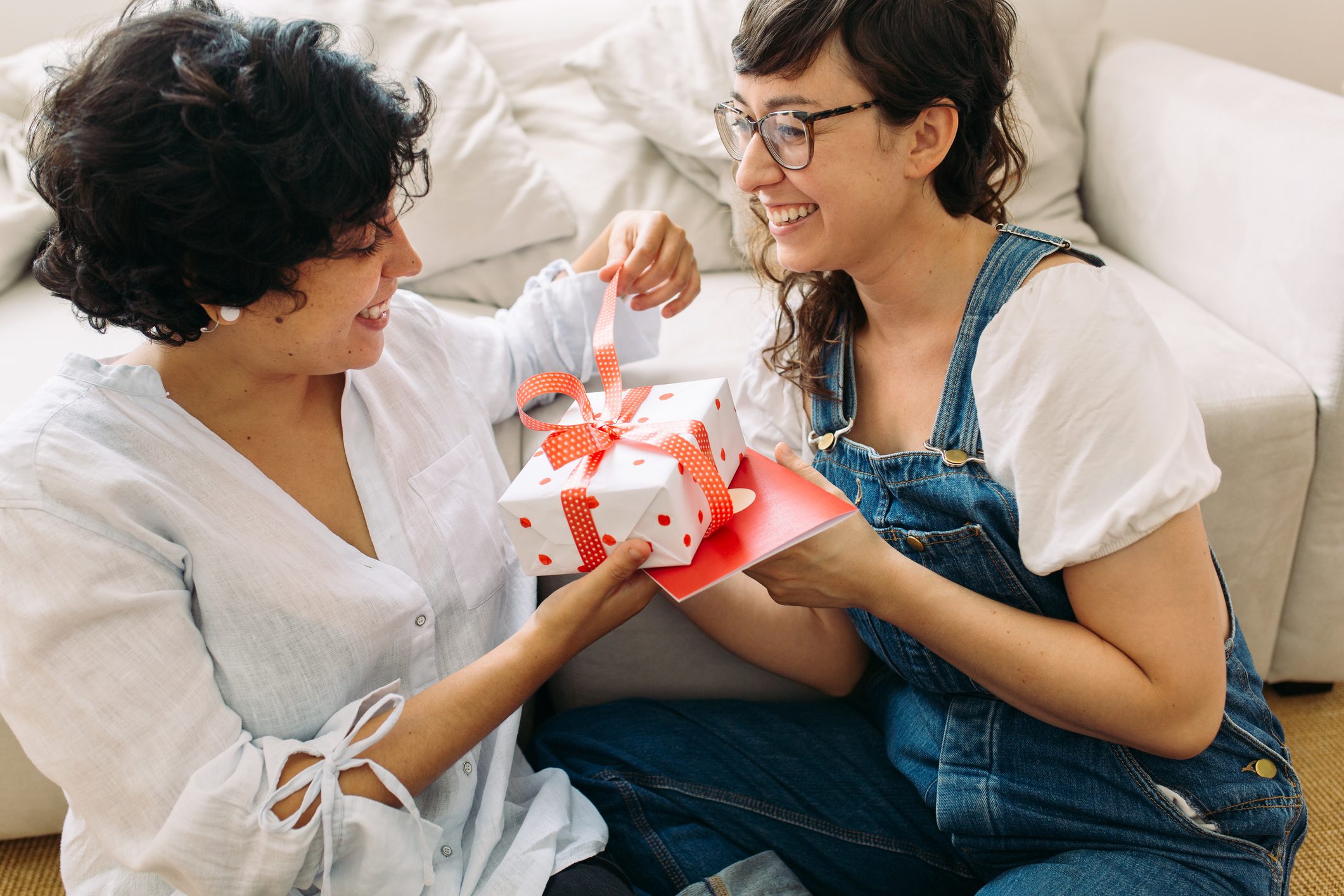 Smiling couple opening a gift together