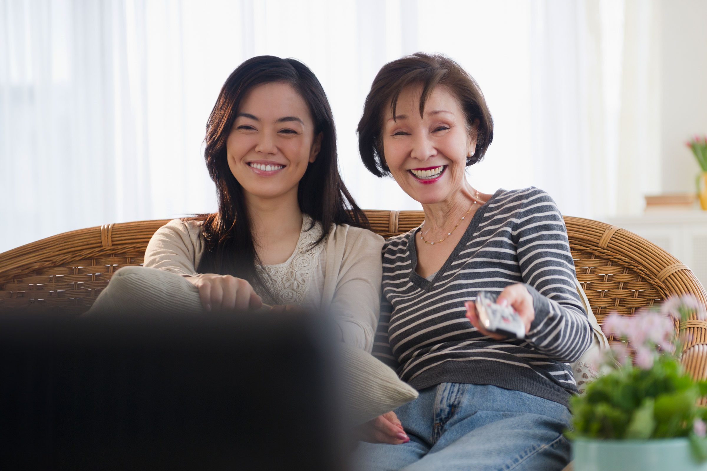 mother and daughter watching home movies on a tv