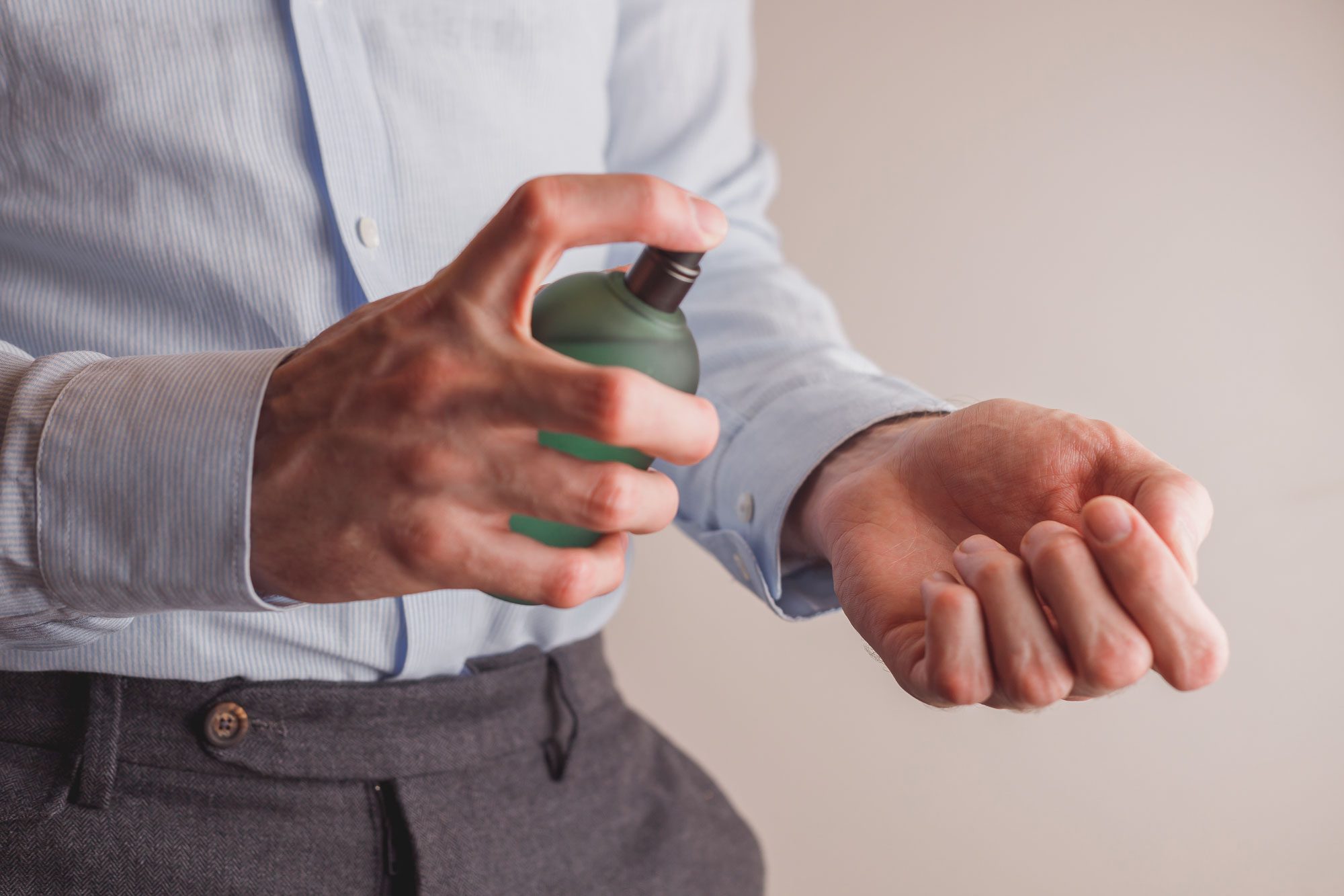 Man In Formal Wear Holding Perfume Bottle