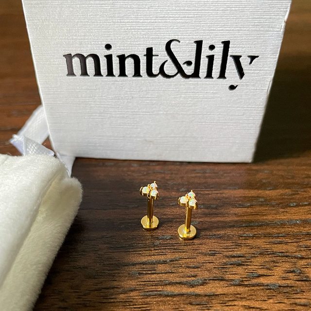 Opal Trio Sleeper Earrings on wooden base