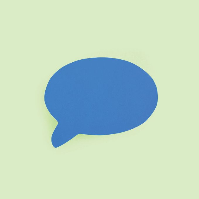 blue paper speech bubble on green background