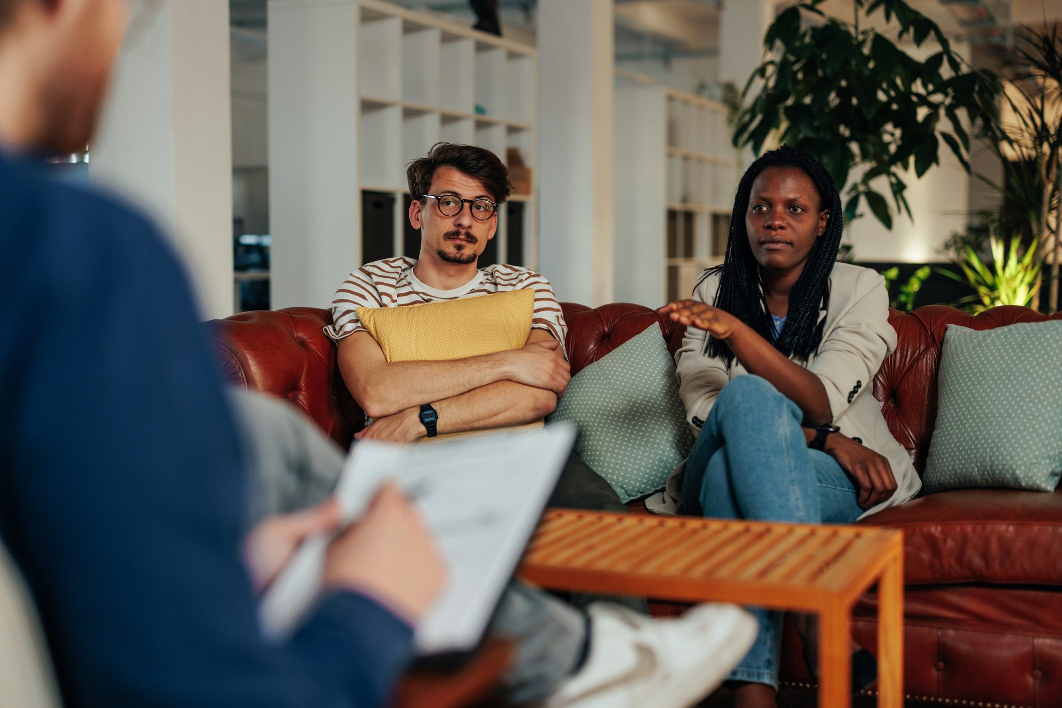 Young couple discussing problems with therapist