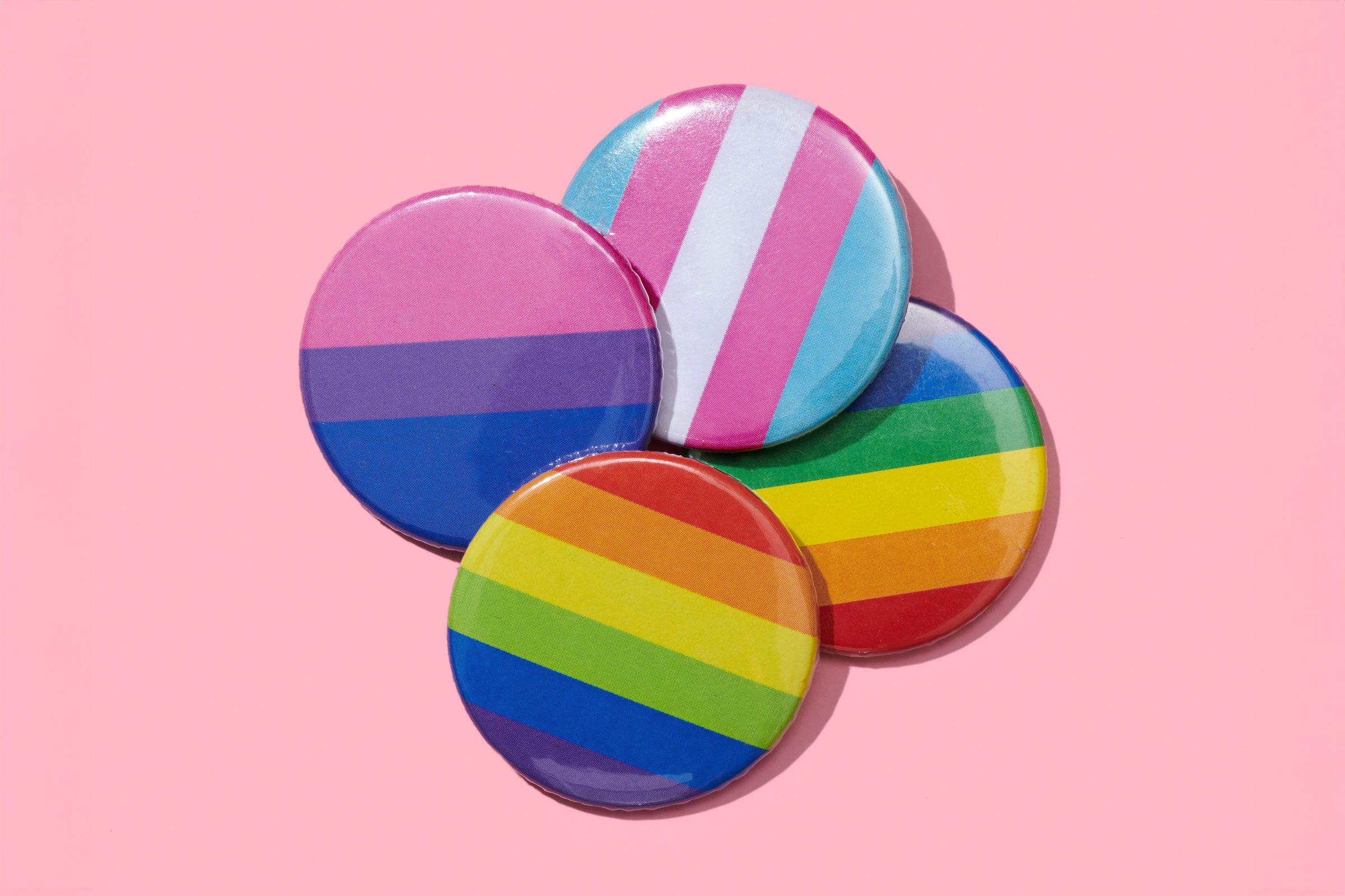 LGBTIQ flags flag patterns on pins on a pink background