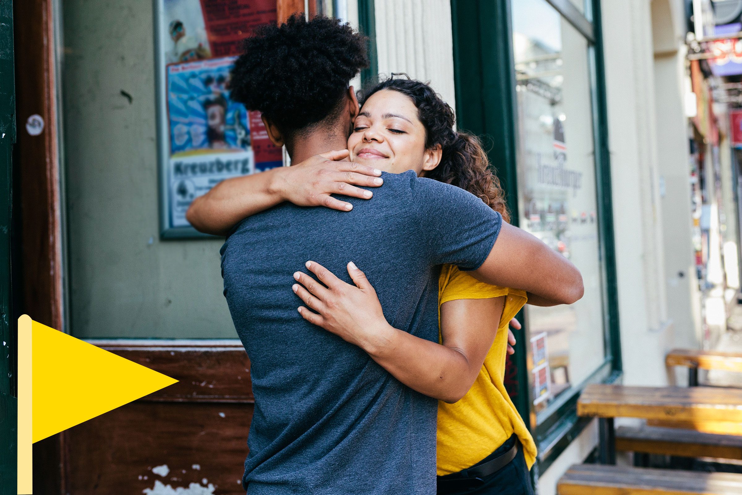 couple hugging good bye after a good date with a yellow flag icon in he bottom left corner