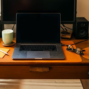 Desktop Workspace in evening lighting with computer that has been shut down for the night