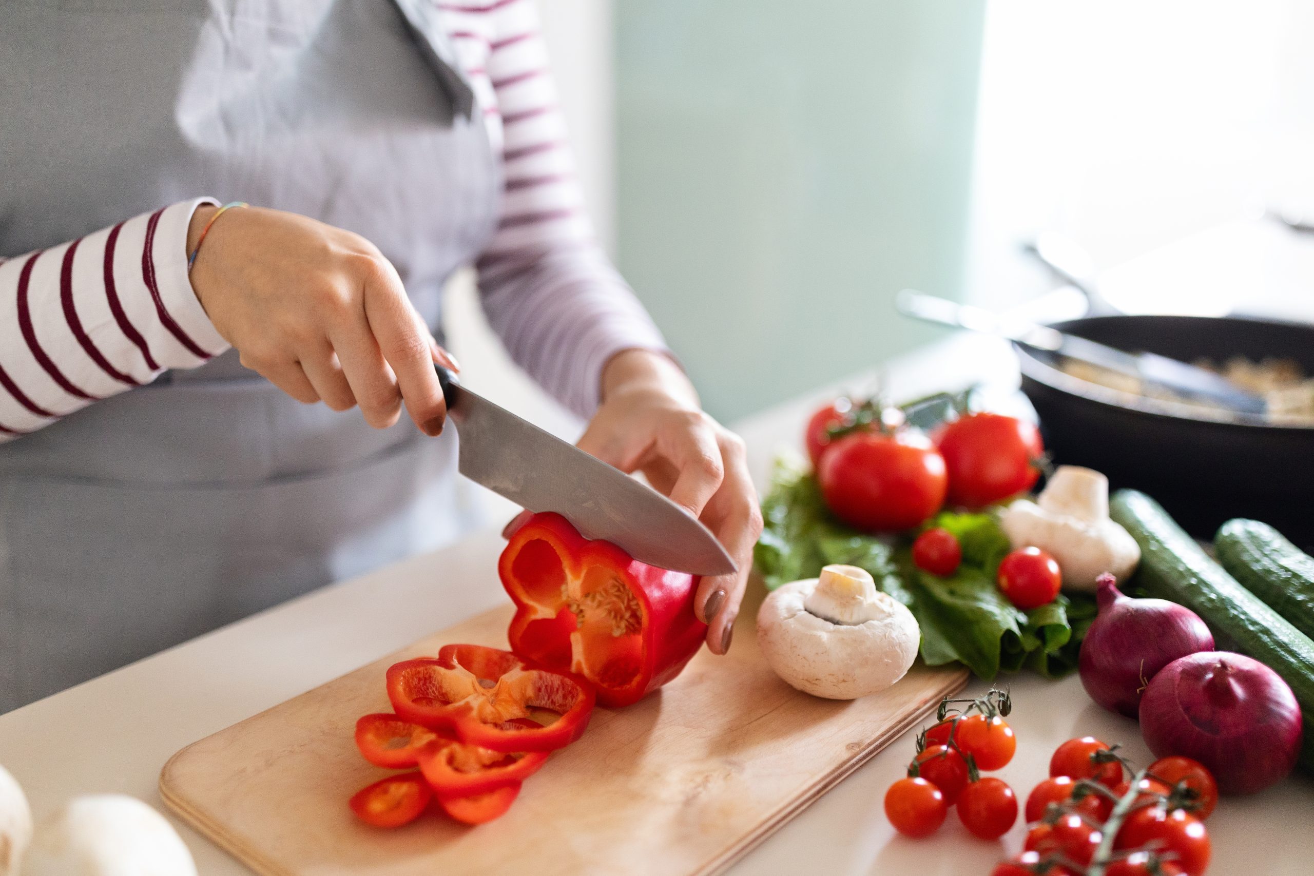 Cooking,concept.,unrecognizable,woman,in,grey,apron,making,healthy,dinner,