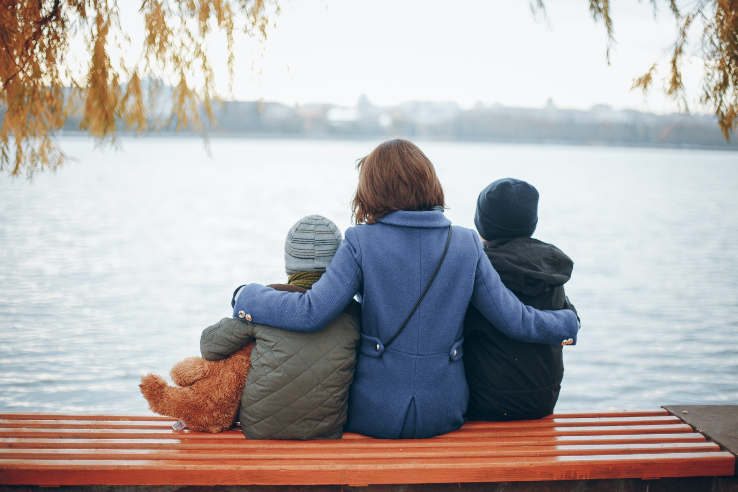 Mother,of,two,boys,sitting,on,a,bench,near,the