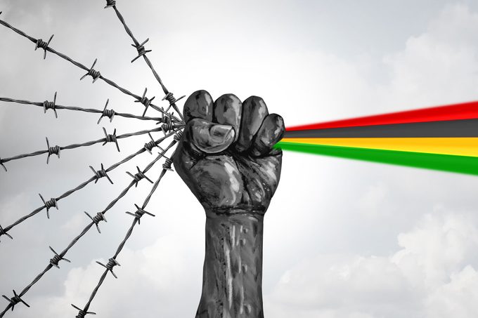 hand holding barbed wire and turning it into american flag colors to represent freedom and Juneteenth