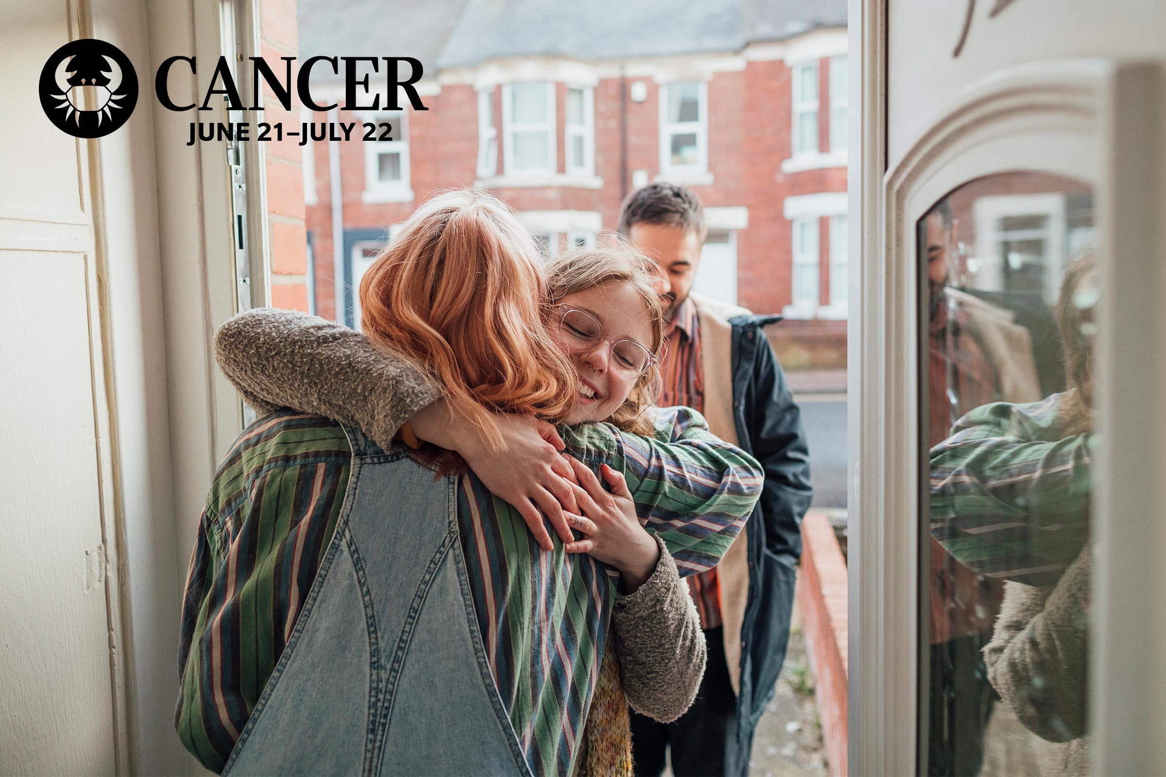 two friends hugging goodbye in the door way of a home