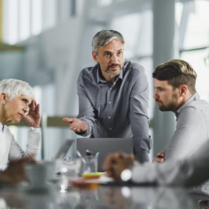 Male CEO talking to his team on a meeting in the office.