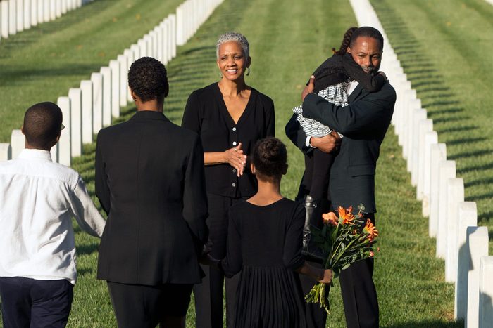 Multi-generation Black family at military cemetery
