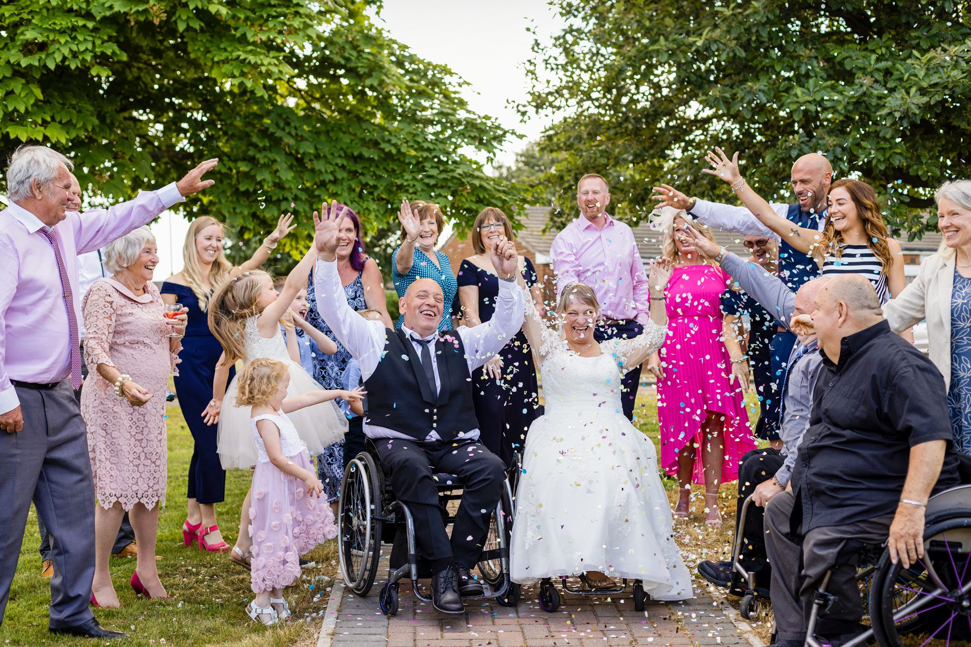 A Bride And Groom Who Are Wheelchair Users That Have Just Been Married At A Venue