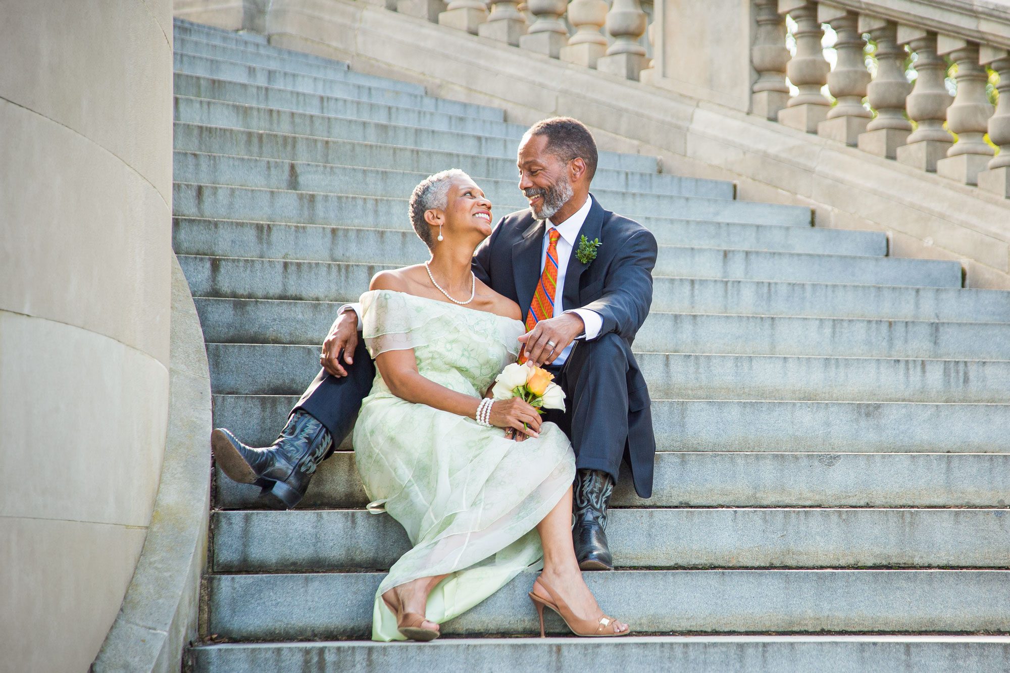 Black Couple Sitting On Stone Staircase