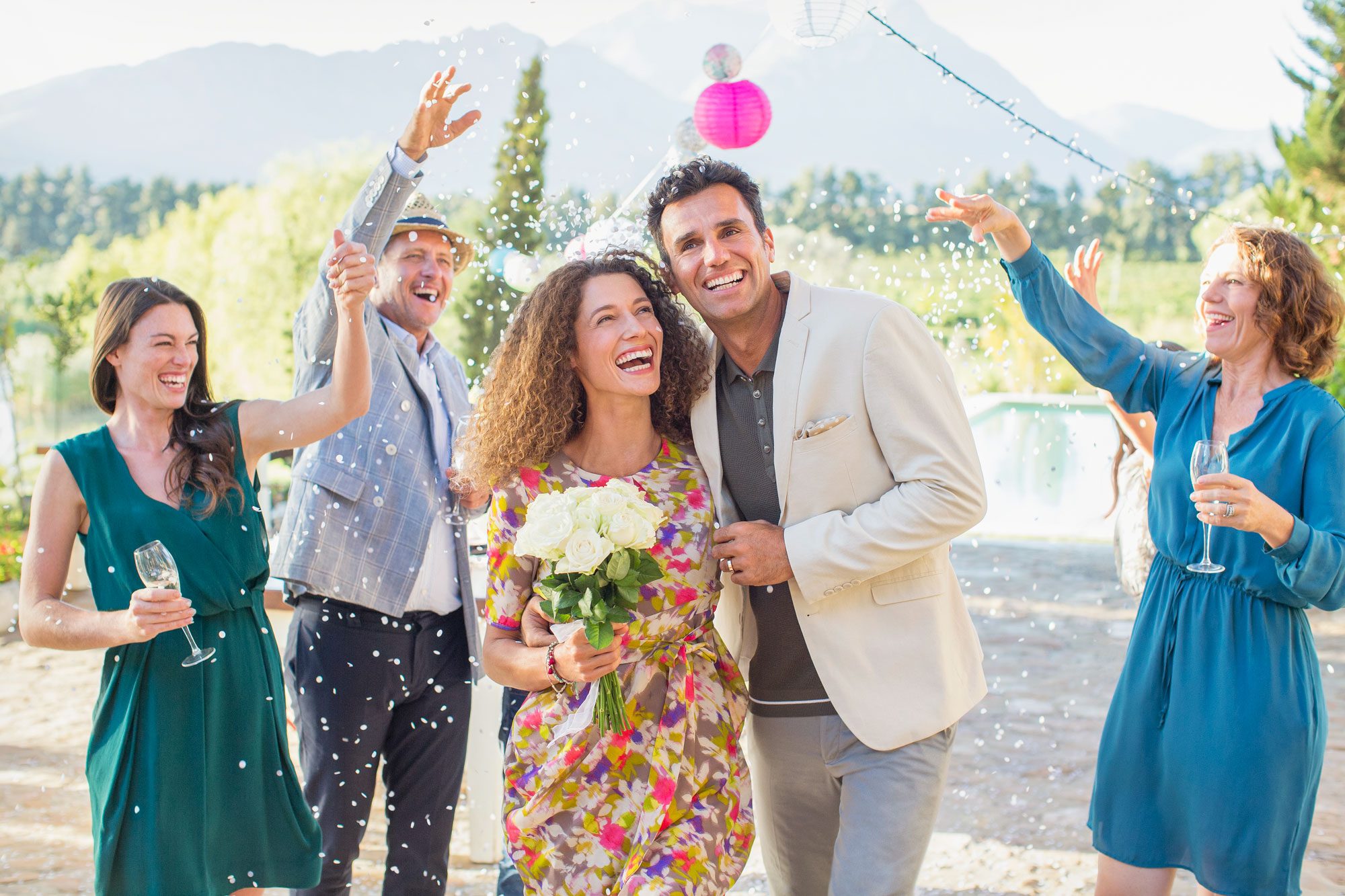 Family Throwing Rice On Newlywed Couple