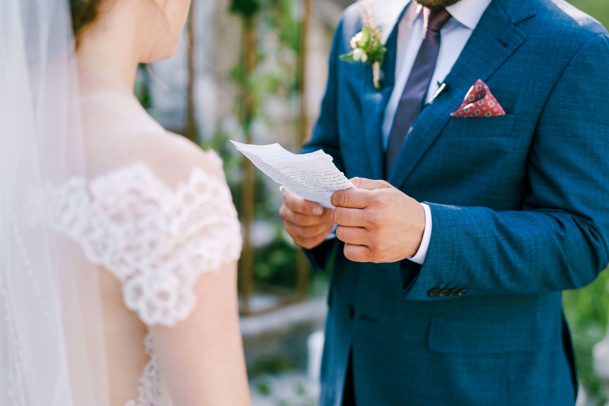 Groom Reads An Oath From A Sheet Of Paper To Bride In A White Dress