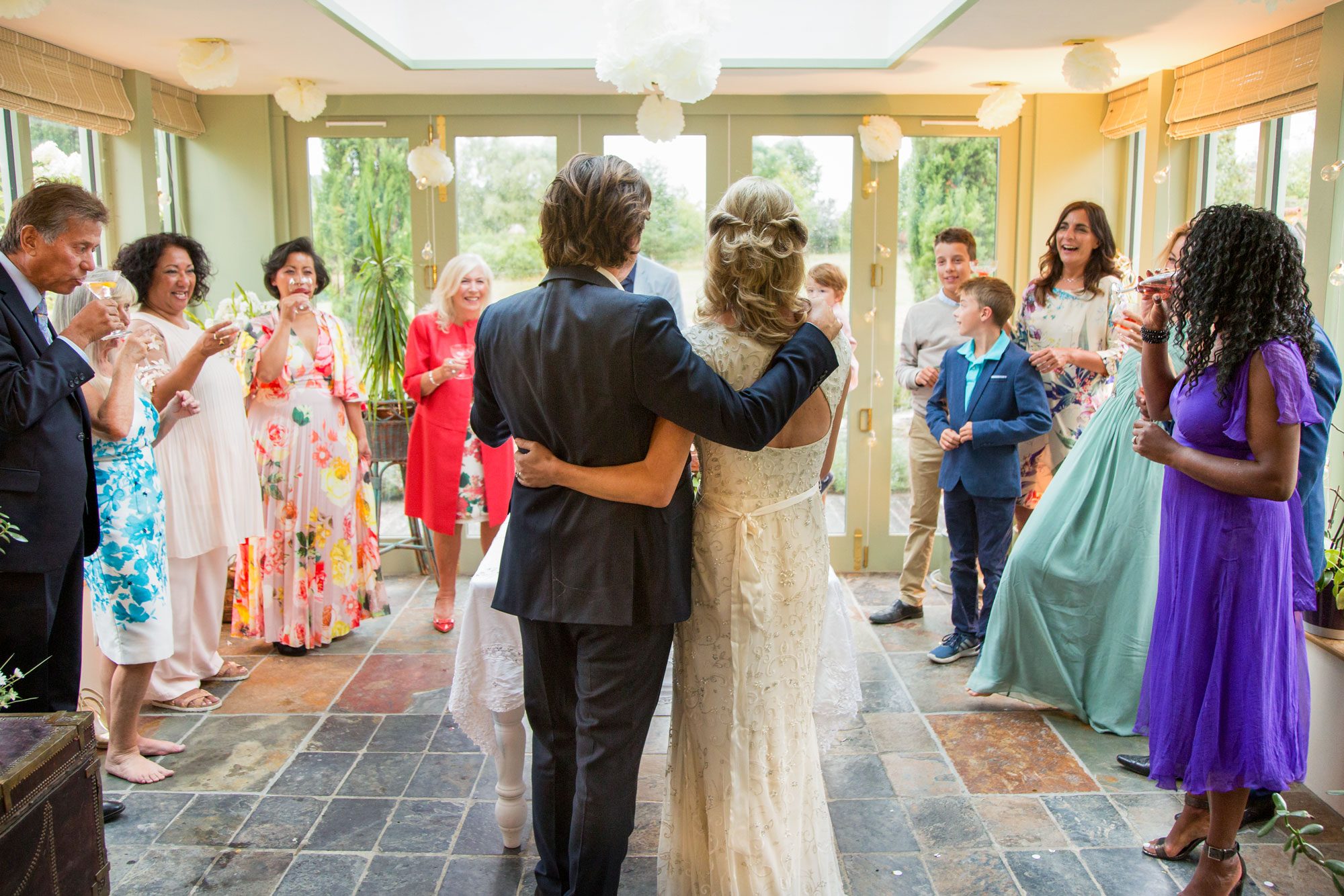 Wedding Guests Toasting To Newlyweds At Reception