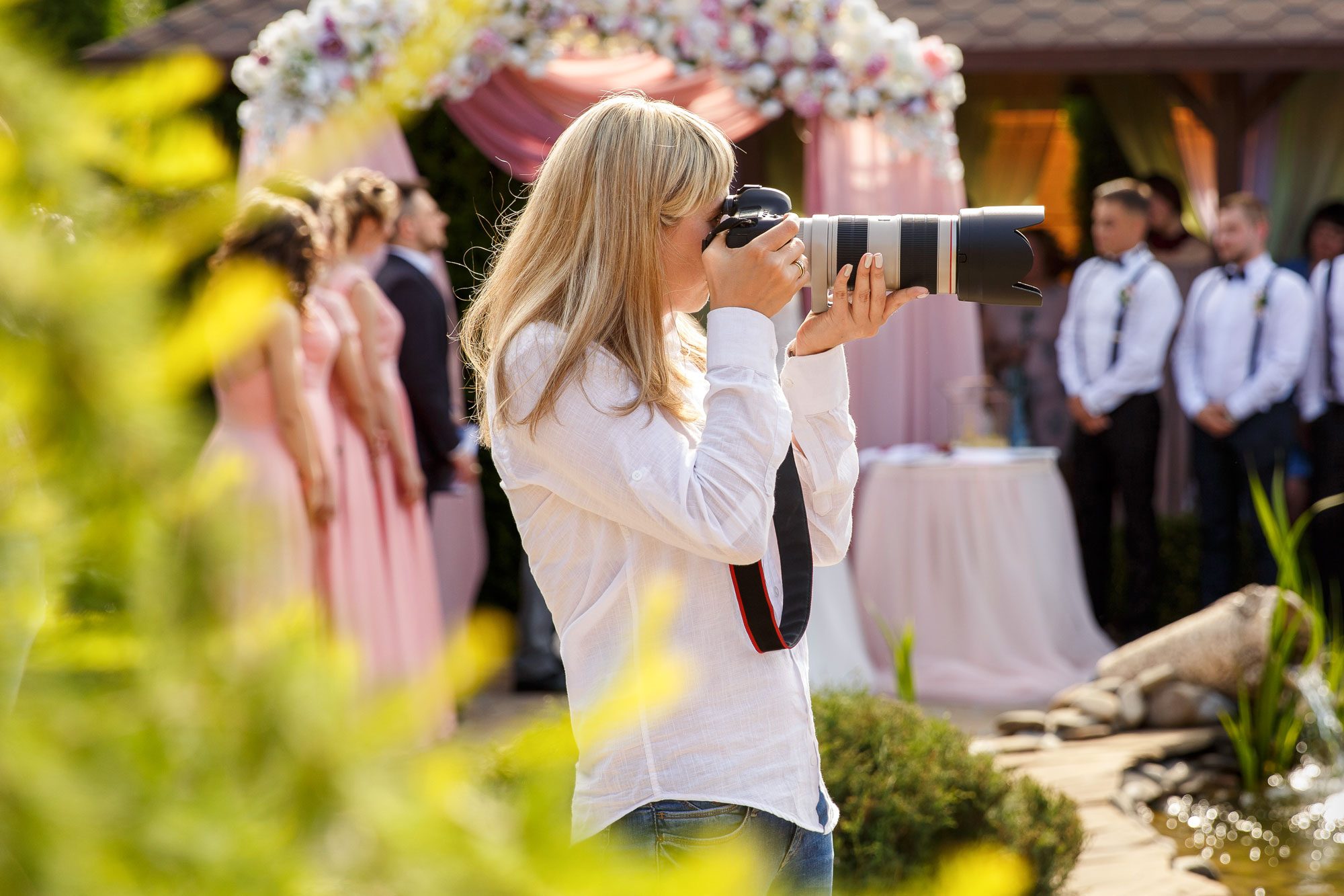 Wedding Photographer With A Professional Camera Working At A Wedding Ceremony