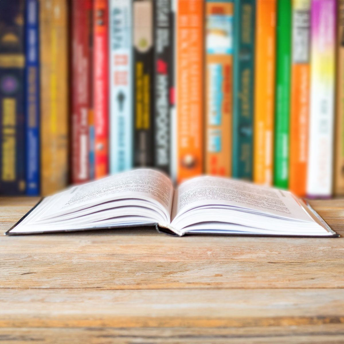 Opened Book On Bookshelf On Blurred Books Background