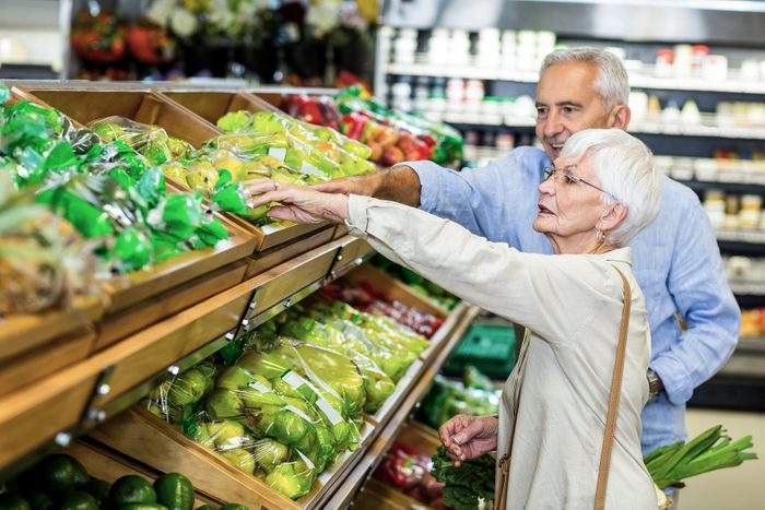 Reaching over people to grab something