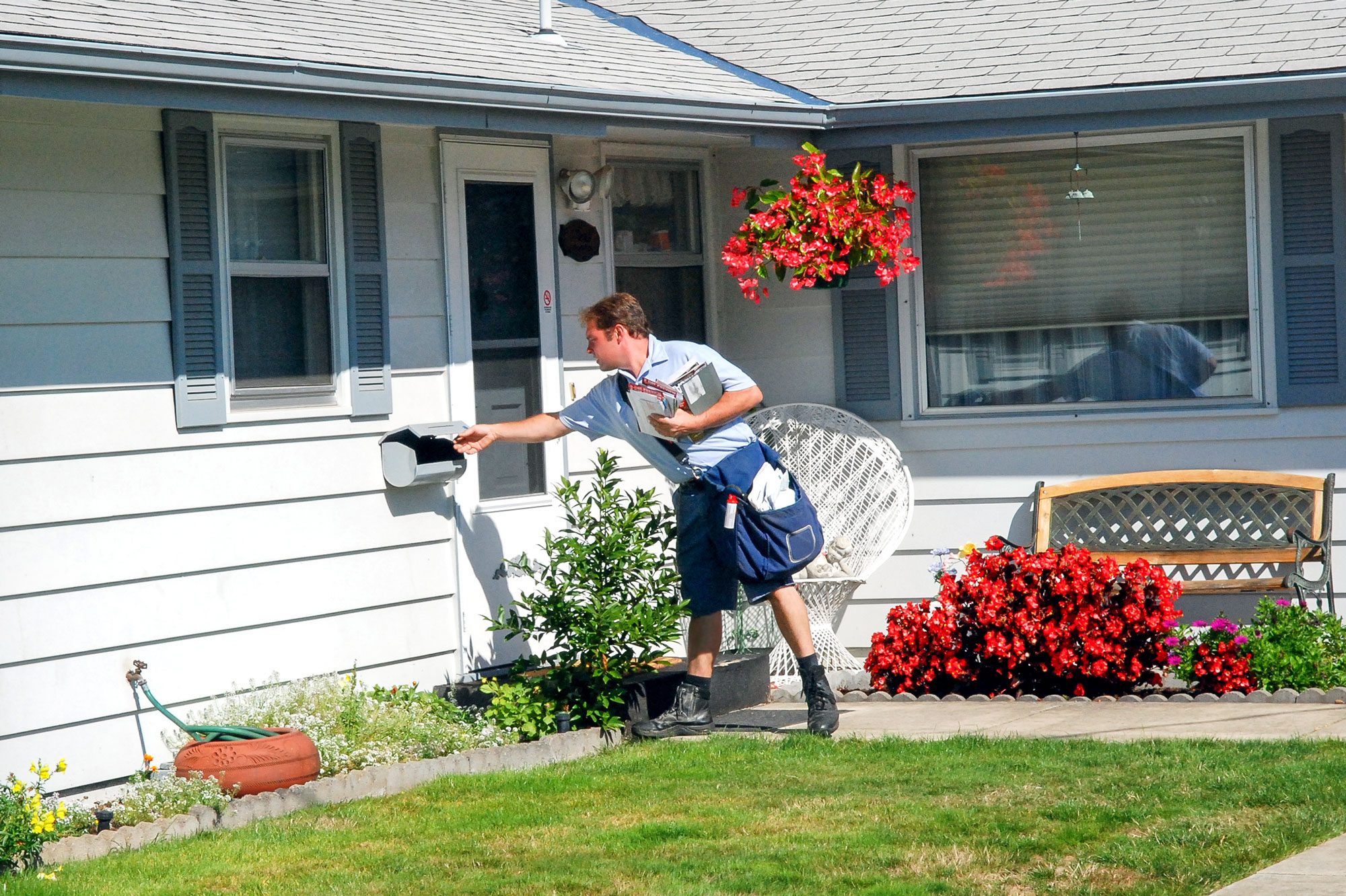 A Postman In His Traditional Shorts At Work