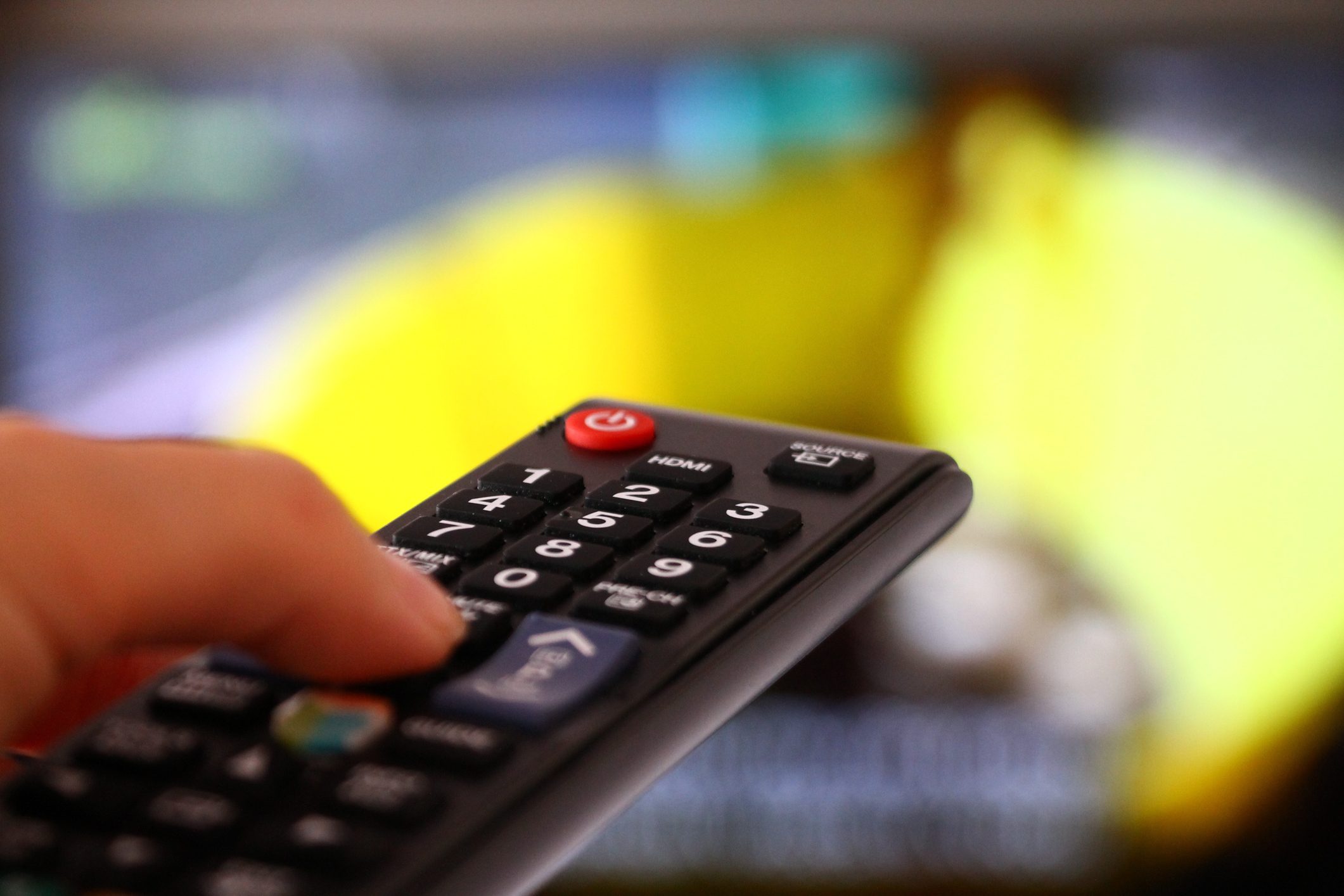 Remote control in woman's hand