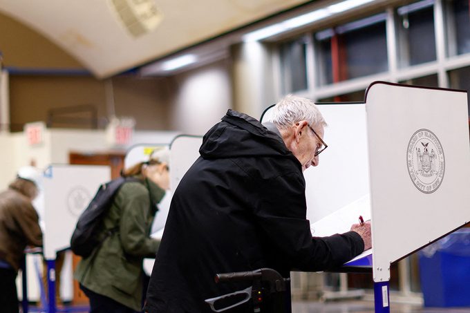 A voter fills out his ballot at the Fashion institute of Technology during first day of early voting in New York on October 26, 2024.