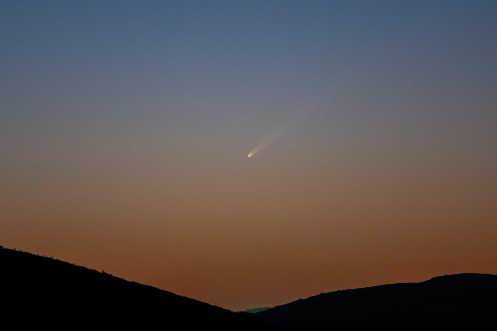 Comet C/2023 A3 (TsuchinshanATLAS) known also as "the comet of the century" is seen crossing the sky during sunrise at Monfrague National Park in Spain