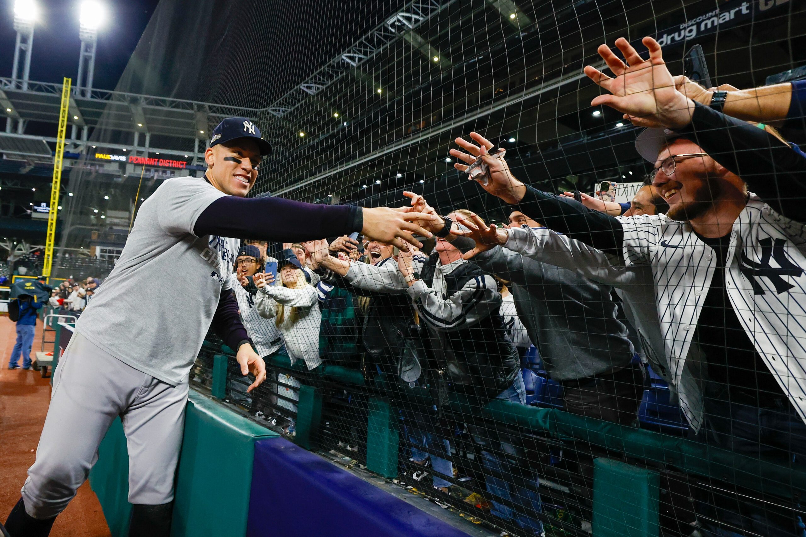 Aaron Judge #99 of the New York Yankees interacts with fans after defeating the Cleveland Guardians in Game 5 of the ALCS