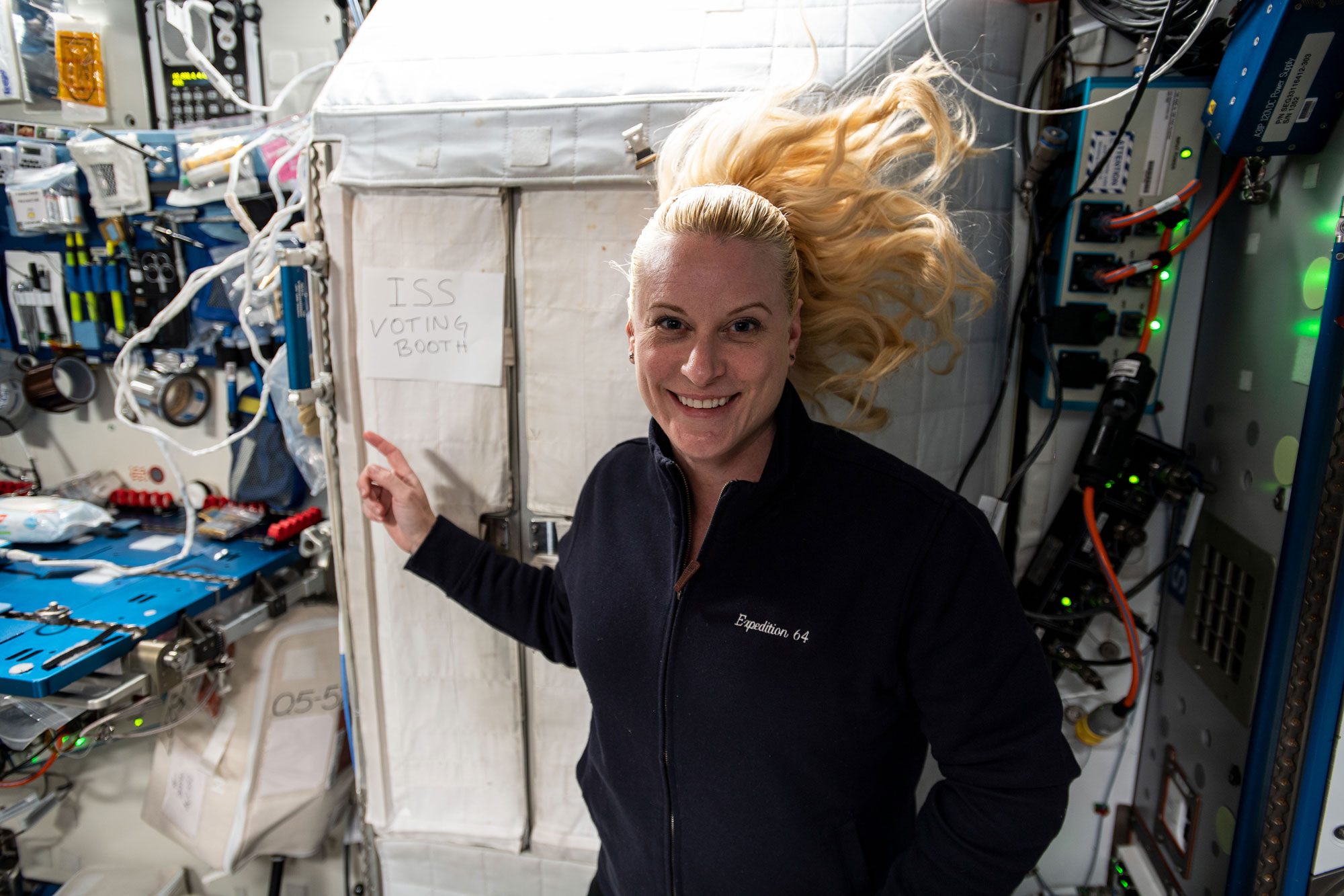 Nasa Astronaut Kate Rubins in front of the "ISS Voting Booth" on the international space station in 2020