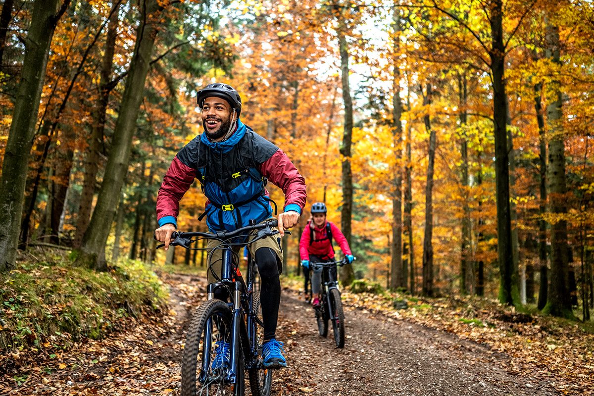 People biking in fall weather.