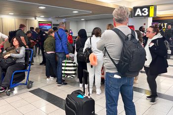 People at the airport congregating around the gate