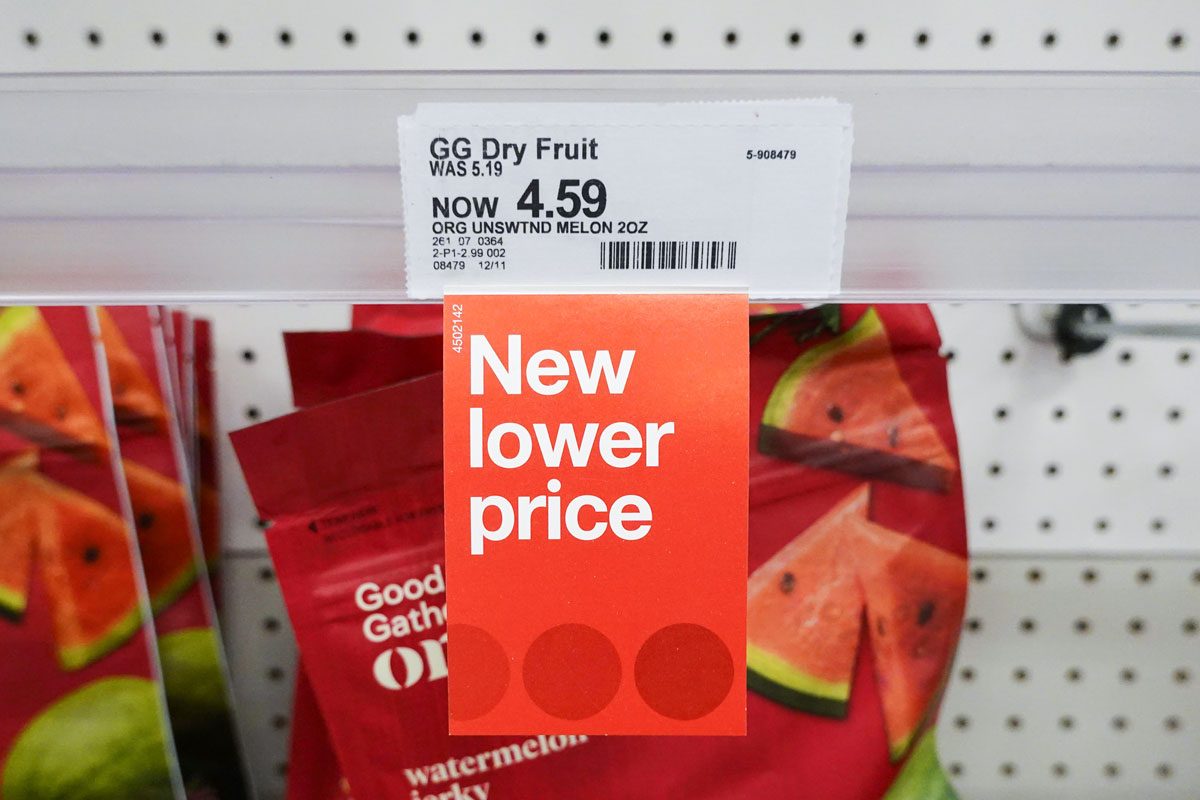 A "New lower price" tag hangs from a shelf at a Target store in Miami, Florida