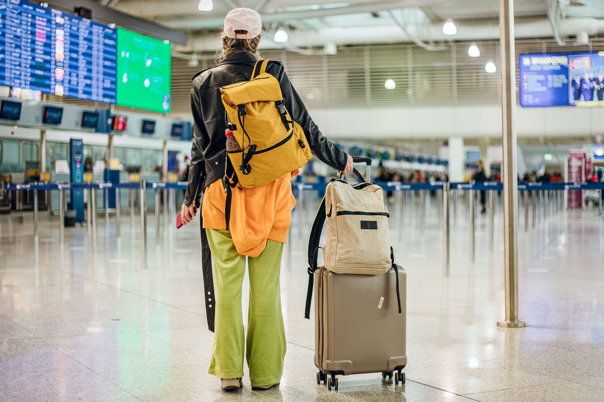 Young Stylish Woman With Bag Pack And Luggage In The Airport