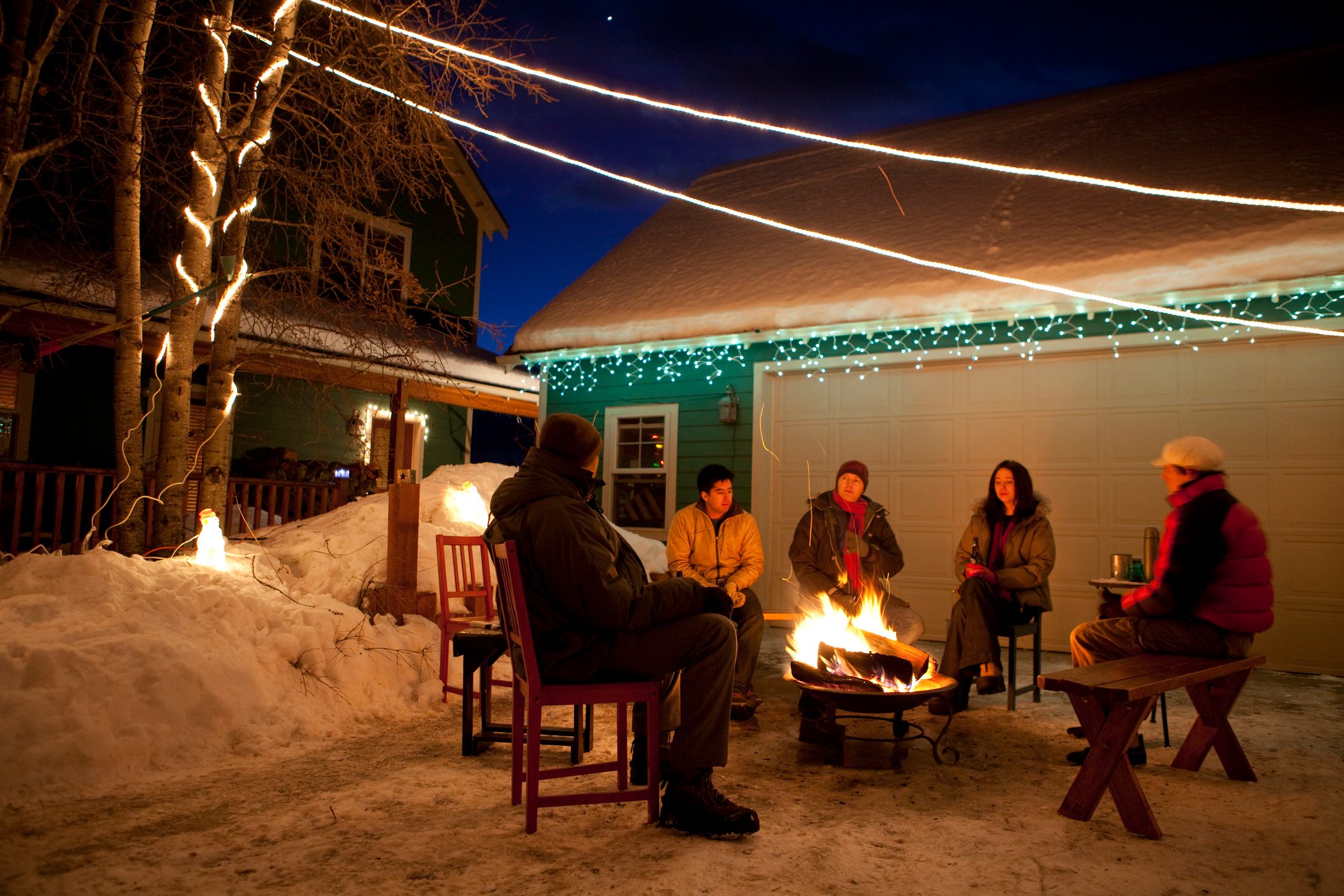 Group of friends enjoying winter bonfire