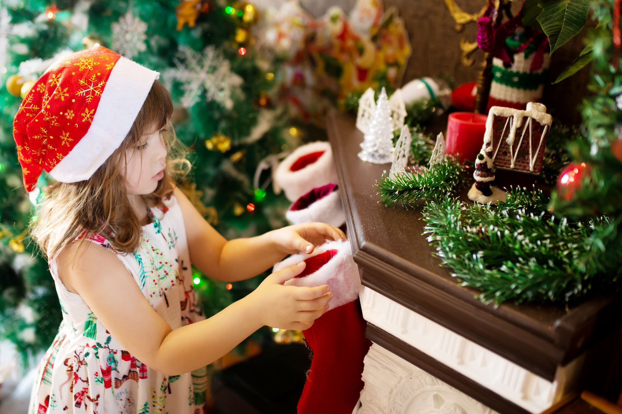 Little Girl Searching For Candy And Gifts In Xmas Socks