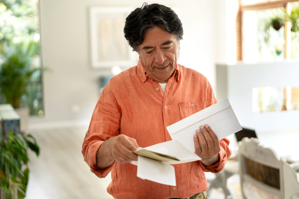 A man looking through mail.