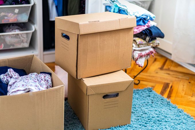 Cardboard Boxes On The Floor In Front Of The Closet