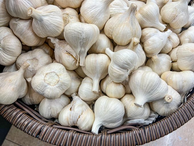 Many garlic bulbs in a basket
