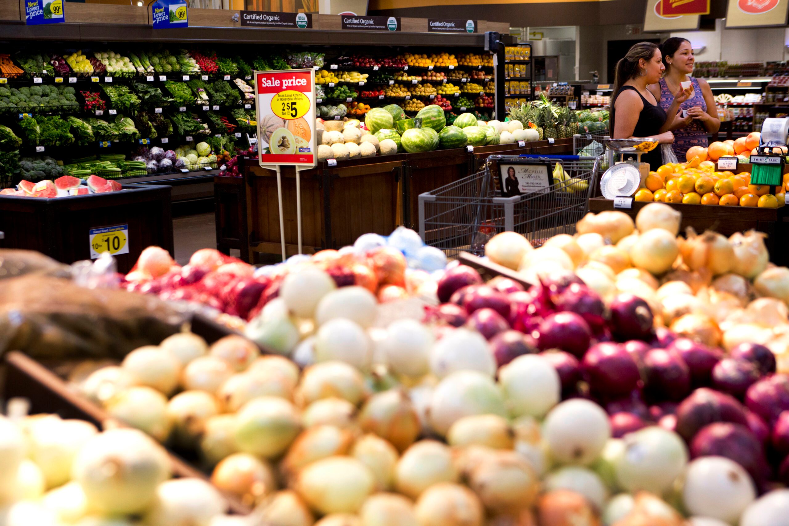 The produce section of a grocery store in Houston, Texas, with a sale sign in the background