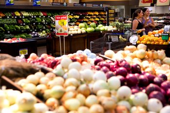 The produce section of a grocery store in Houston, Texas, with a sale sign in the background